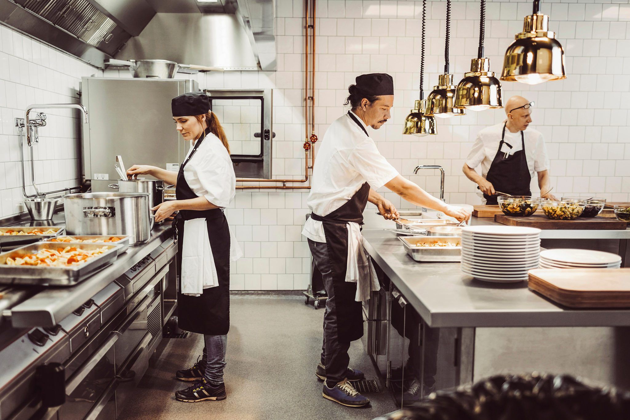 Two cooks in a restaurant with insurance